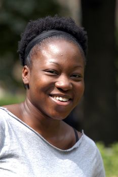 A young african american woman smiles.