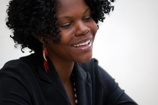 young lady in business attire smiles