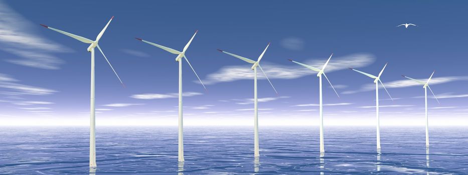 Bird flying upon wind turbines in ocean by beautiful day