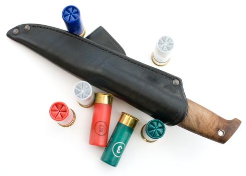 The hunting knife in a black sheath and cartridges.