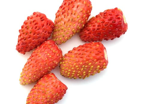 Red wild strawberry on a white background a close up.