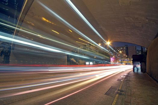 blurred bus light trails in downtown night-scape 