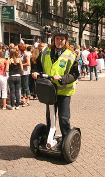 Police woman on electric scooter Segway