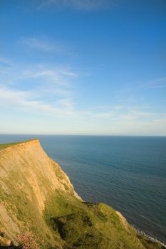 View of the cliffs and the English Channel from the coast of Dorset as the sun sets