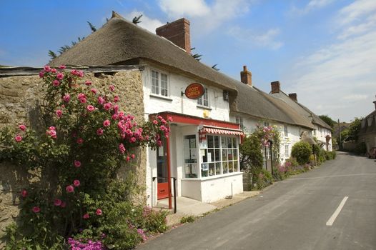 Row of pretty English traditional thatched country cottages in the small village of Abbotsbury in Dorset.