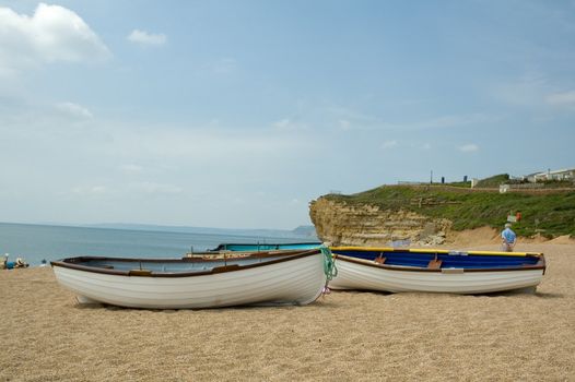 beach scene with a group of small boats on the gravel