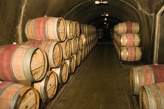 Wine barrels in a storage cave at a winery in Napa Valley