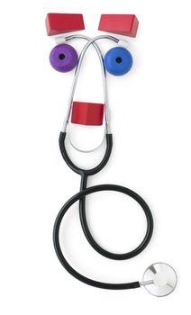 A friendly face formed from a stethoscope and red, blue and purple building blocks.