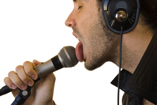 Profile close up of a young man in a leather jacket licking a microphone.