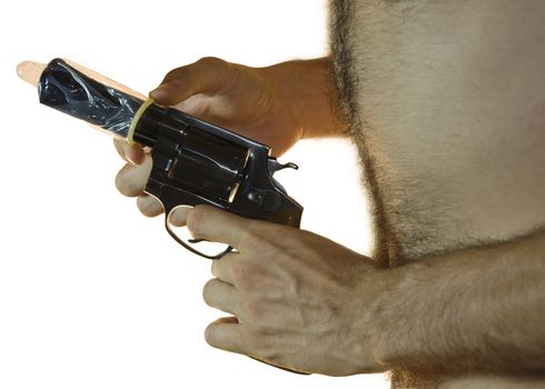 Cropped shot of a male hand holding a .38 caliber with a condom on it and hairy chest from the side. White background.