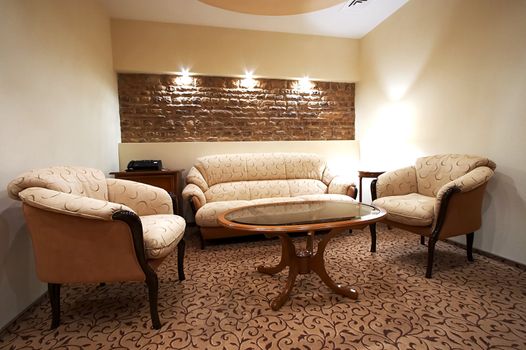 Sofa and two armchairs in modern hotel