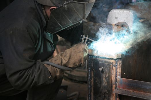 The welder behind work at a modern factory