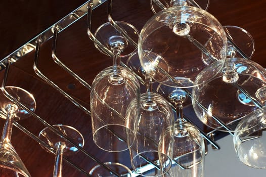 Beautiful wine glasses above a bar rack