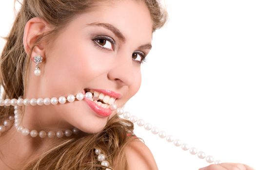 Beautiful girl with white teeth and a string of pearls between her teeth