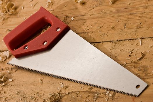 tools series: saw with red plastic handle
