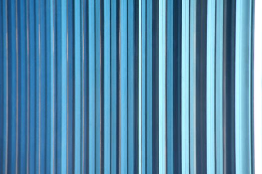 A shot of blue decorative glass tiles partitioning the windows of an office building's facade makes a great gradient background abstract. Horizontal version.