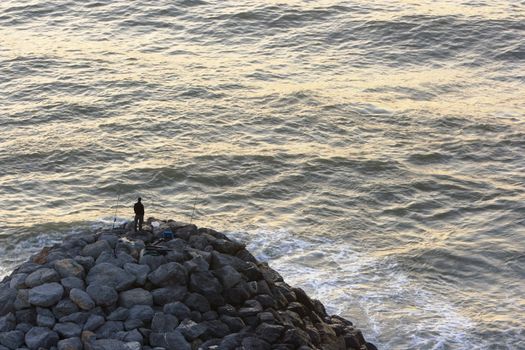 Image of people practicing the sport of sea fishing