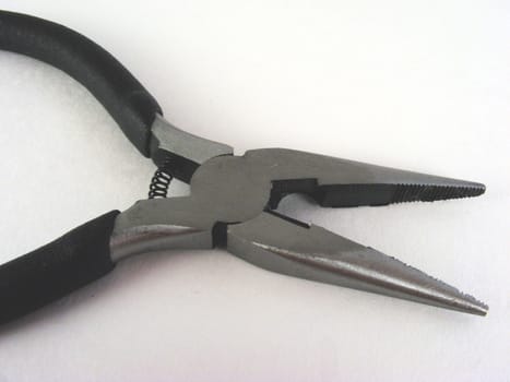 A pair of needle nose pliers.