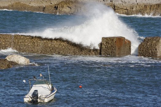 a lonely boat protected from the wild sea