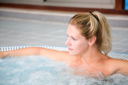 Beautiful blond woman relaxing in the whirlpool