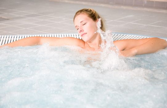 Beautiful woman relaxing in a bubble bath