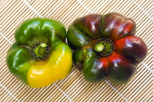Big bell peppers on wooden mat