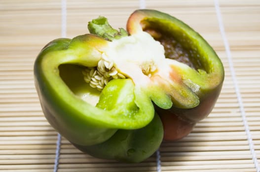 Half of bell pepper on wooden mat