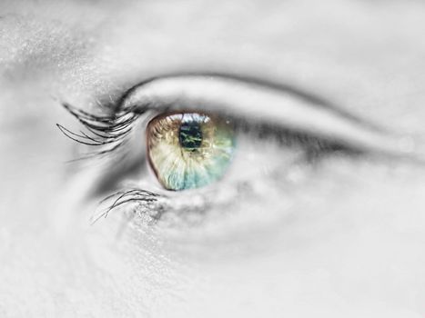 Macro of a beautiful caucasian  girl eye with selective coloring