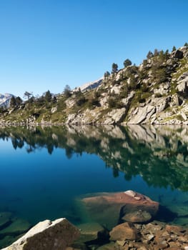  Beautiful high mountains lake with water reflection Gourget de Madamet ou gourg de Rabas in Neouvielle natural reserve