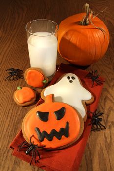 Halloween cookies with milk on oak table