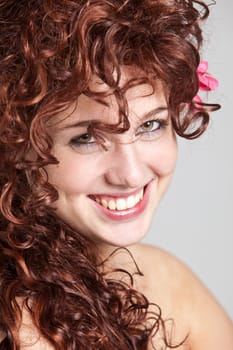 Beautiful redhaired girl in closeup portrait smiling happily