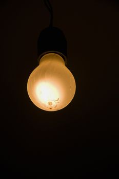 yellow glowing lamp with dark background