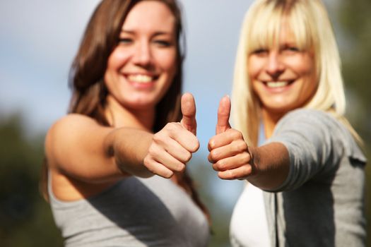 Two young women laughing positive- close up - from the thumbs 