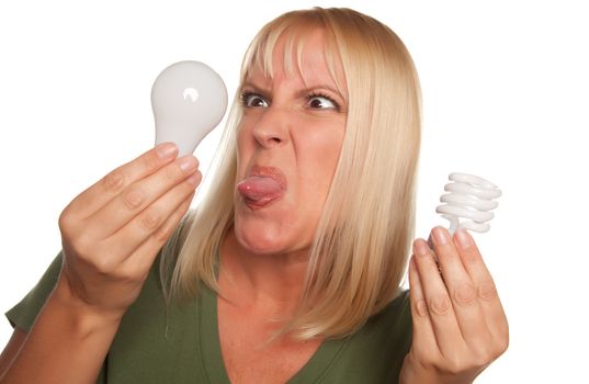 Funny Faced Woman Holds Energy Saving and Regular Light Bulbs Isolated on a White Background.