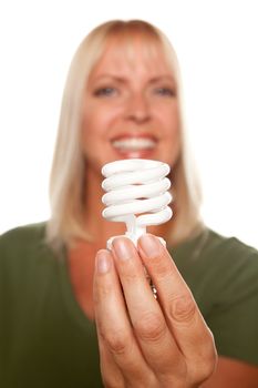 Attractive Blonde Woman Holds Energy Saving Light Bulb Isolated on a White Background with Narrow Depth of Field.