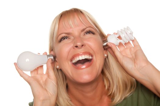 Funny Faced Woman Holds Energy Saving and Regular Light Bulbs to Her Ears Isolated on a White Background.