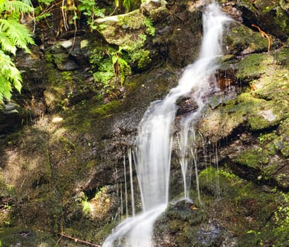 Little falls over a rocky background