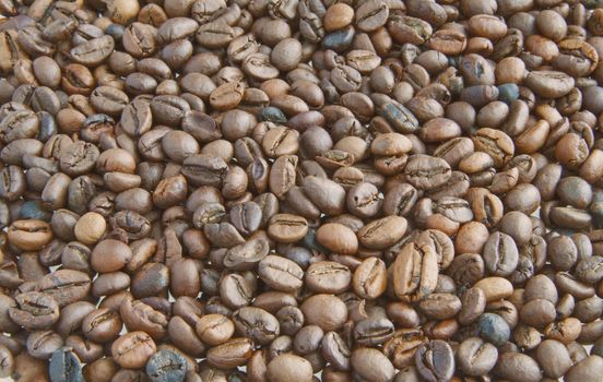 Background completely full of coffee beans of different colors