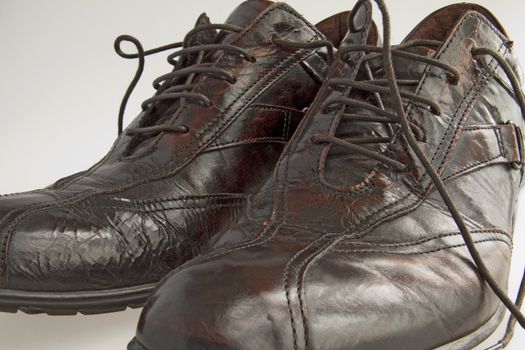 Closeup of man's leather shoes, gray background