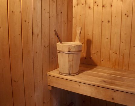 The interior of a wooden sauna with tub