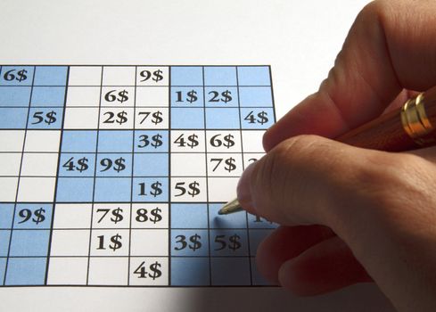 Male man playing sudoku with dollars symbol in it