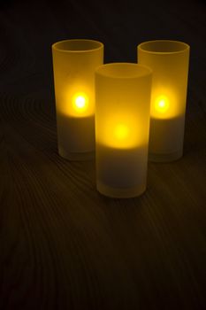 Three candles on a wooden table