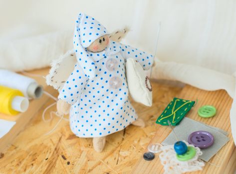 Funny handmade rag-doll with yarn and needles
