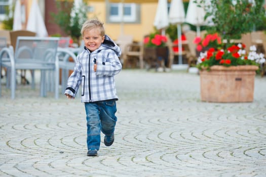 cute little boy outdoors in city street