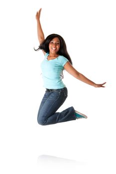 Beautiful happy smiling African Caribbean teenager jumping from happiness to celebrate, wearing blue shirt and jeans, isolated.