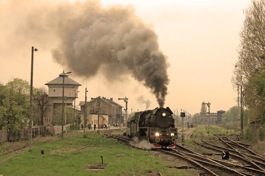 Steam retro train starting from the station
