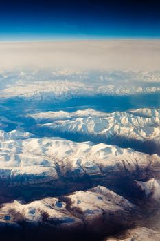 Aerial view of snowcapped mountains in Yukon Territory, Canada.