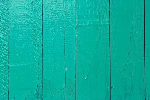 Fragment of old wooden fence painted in bright aquamarine