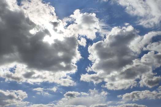 Heavens. Sun behind the cloud, warm summer day