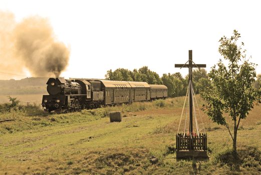 Old retro steam train passing through polish countryside
